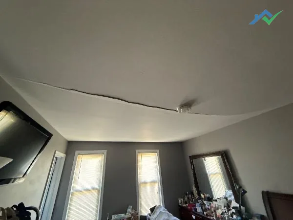 A sagging bedroom ceiling in Burke, VA, dropped away from the joists above the bed.
