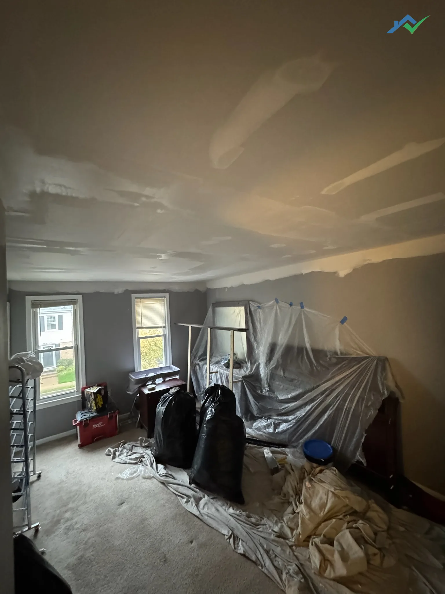 Taped and mudded seams across the new Burke ceiling drying before sanding and primer.
