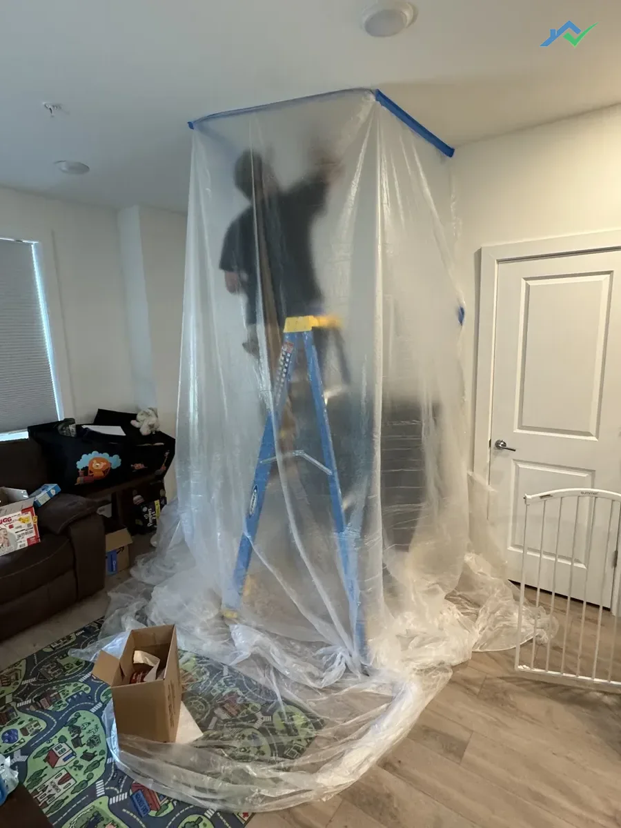 Sanding and smoothing ceiling drywall repair before painting
