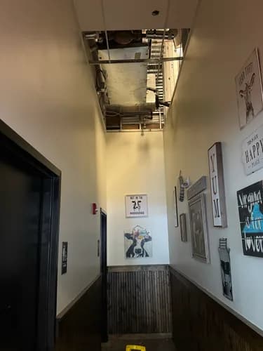 Demoed commercial drop ceiling at Ashburn restaurant showing HVAC ductwork above