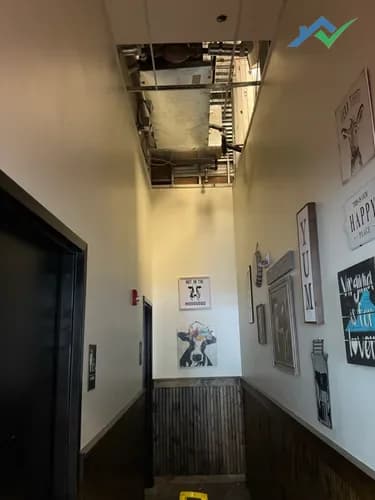 Demoed commercial drop ceiling at Ashburn restaurant showing HVAC ductwork above