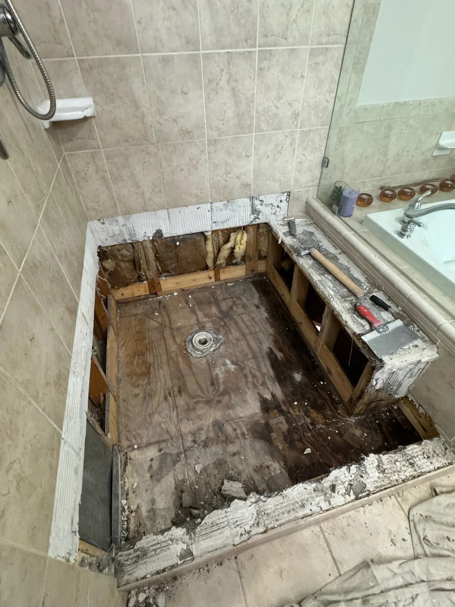 Water-damaged subfloor exposed in the Fairfax Station bathroom.