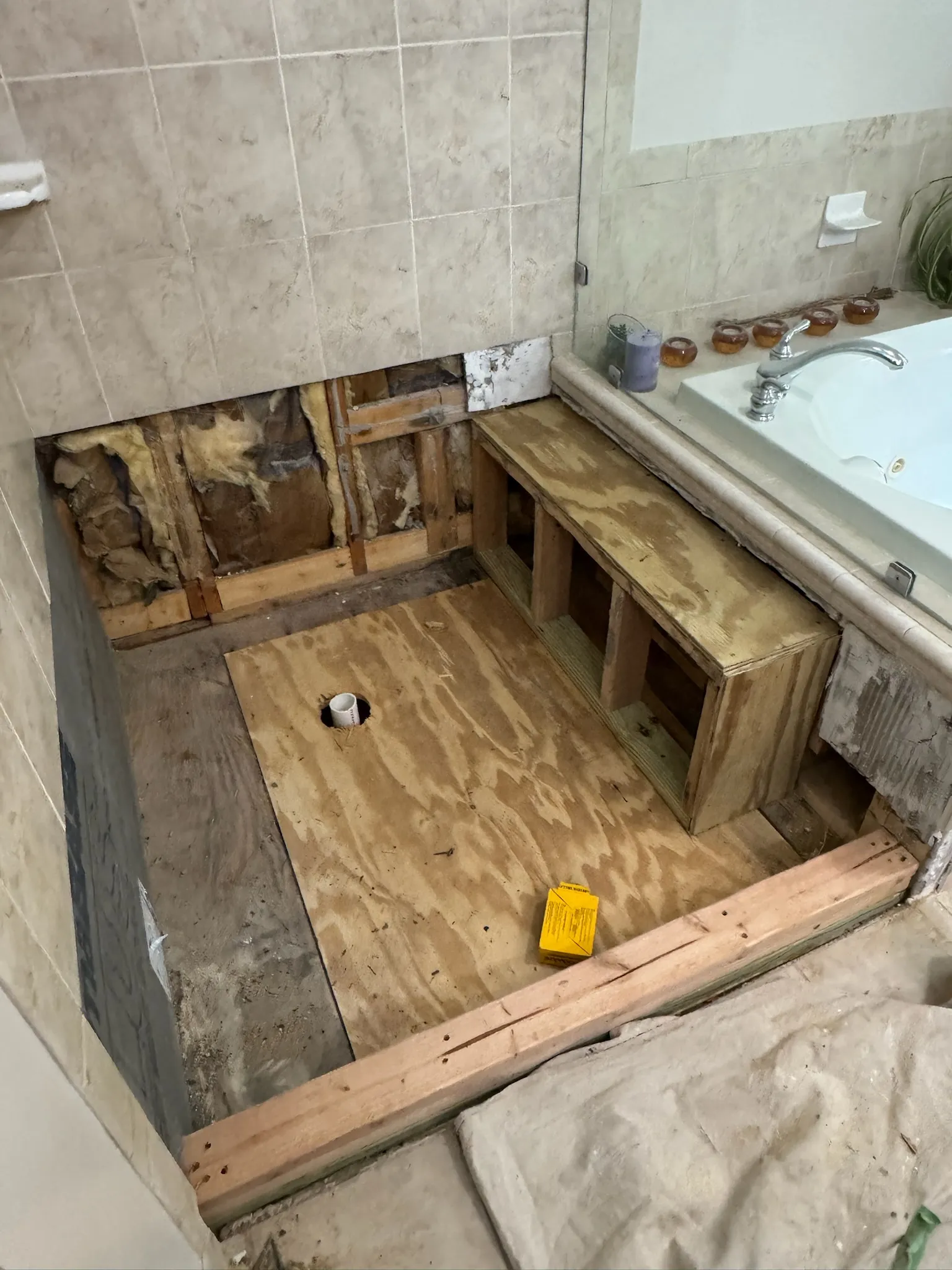 New subfloor installed in the Fairfax Station shower, cut around the drain.