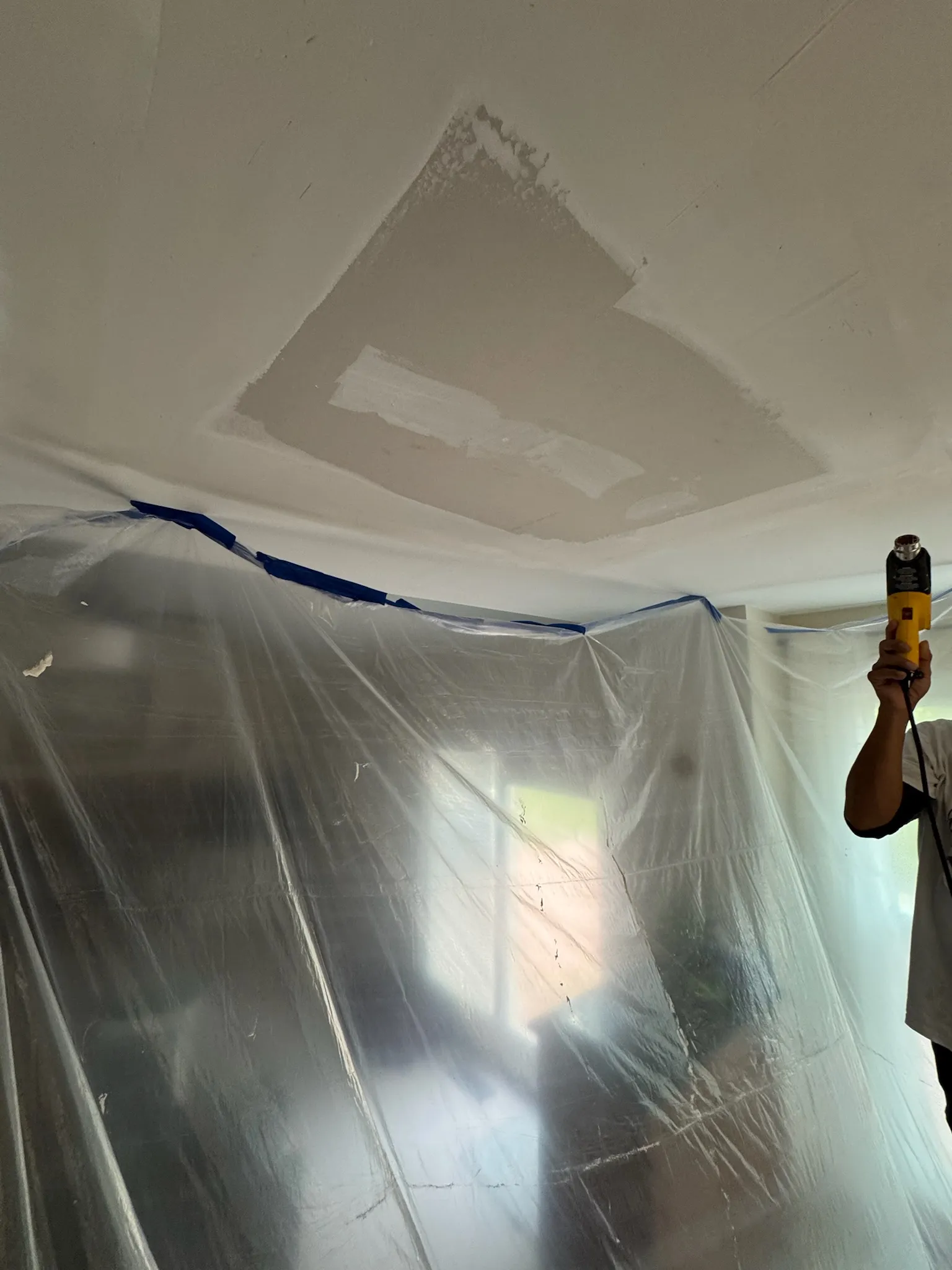 Plastic containment downstairs, prepared for the final kitchen ceiling drywall repair.