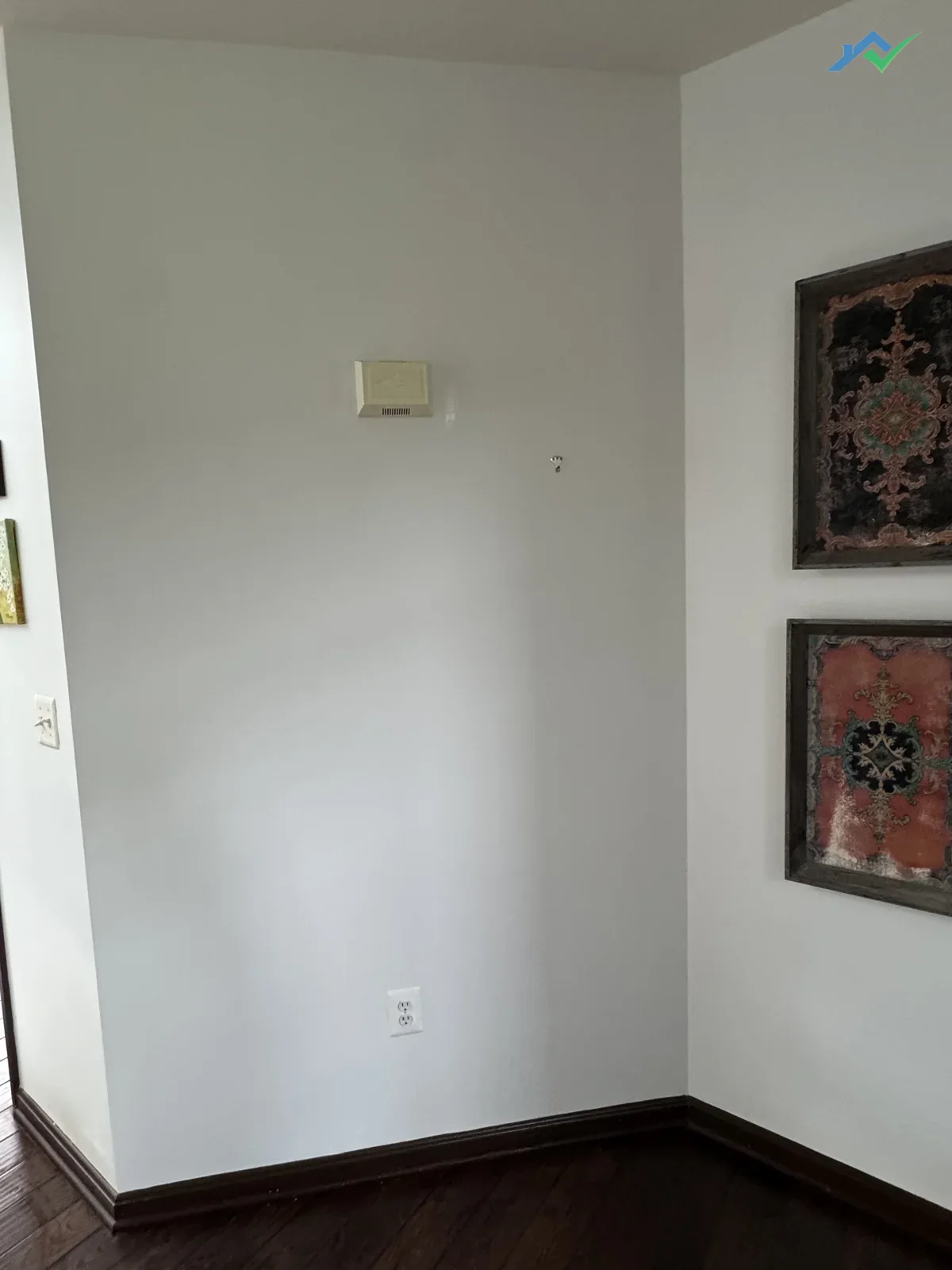 Same wall in this Purcellville, VA home after HouseWorks closed up the plumber's access cut — the doorbell cover is back in place, the drywall is patched, primed, and painted, and the whole section blends into the surrounding wall with no visible seam.