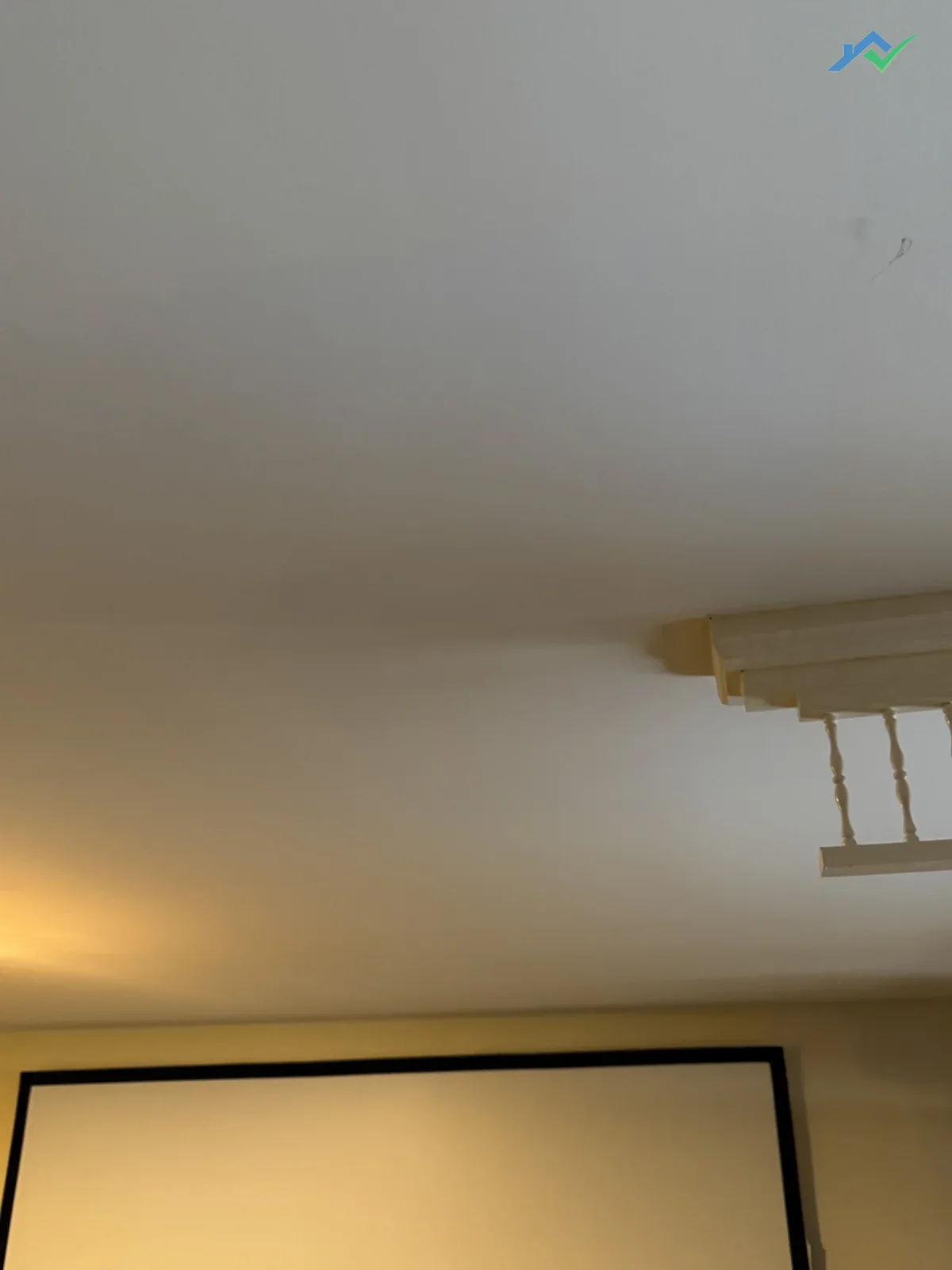 Same basement ceiling in the Purcellville, VA home after repair — the small rectangular hole is gone, the ceiling now reads as one continuous smooth surface.