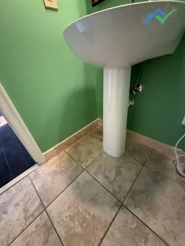 The Purcellville, VA guest bath wall after drywall repair — patched, primed, and painted with no visible seam.