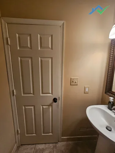 Purcellville, VA guest bathroom before drywall repair showing dated trim and wall color.